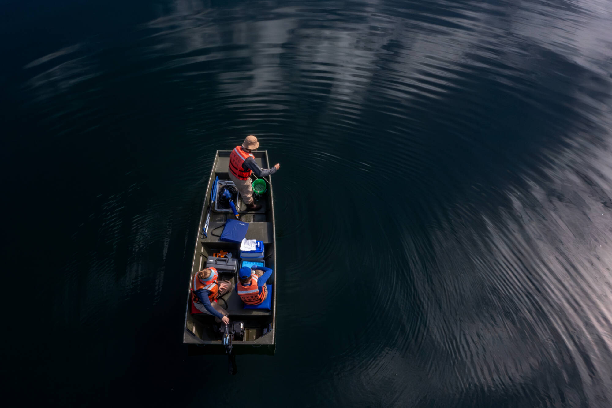 A student and faculty member on a boat conducting research.